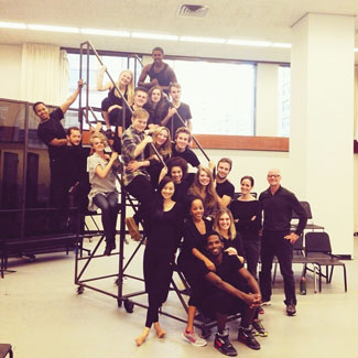 drama students pose on stairs