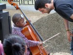 Cello student Patrick McGuire with a youngster
