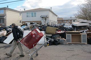 man carting away debris