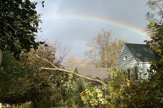 Rainbow appears over damaged house